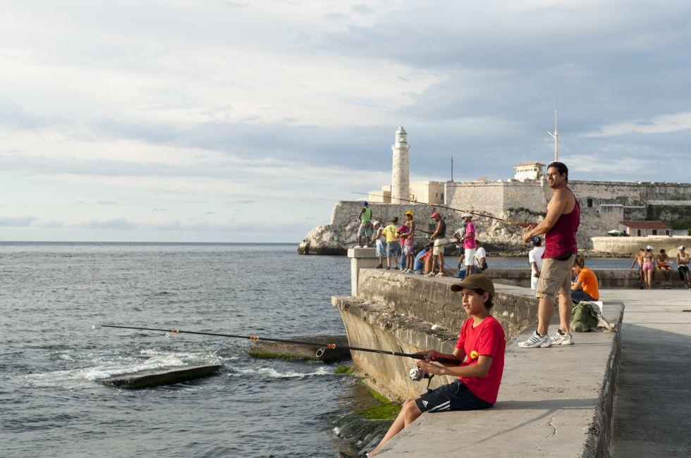 Cubans gather to fish and socialize on the wall of the Malecon, a popular hangout for city residents. 