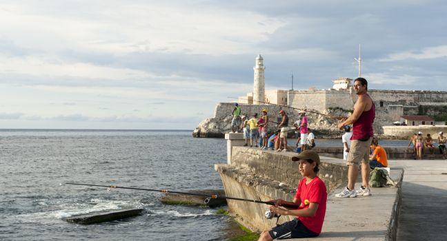 Cubans gather to fish and socialize on the wall of the Malecon, a popular hangout for city residents. 