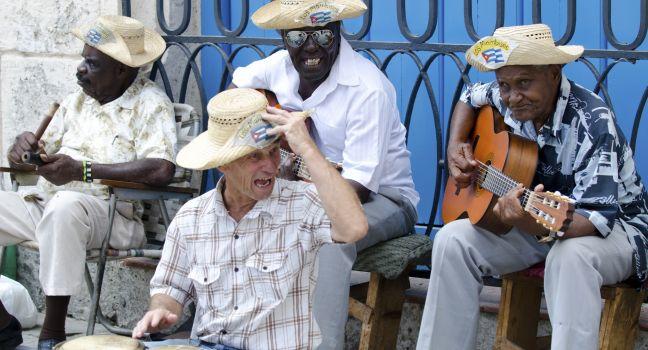 Cuban street musicians sitting in the cathedral square, performing for the tourists with traditional Cuban music. 