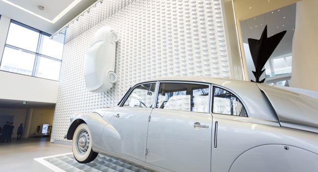 Munich, Germany - January 03 2016: Old white car on the exhibition in Pinakothek der Moderne museum, situated in the city centre of Munich.