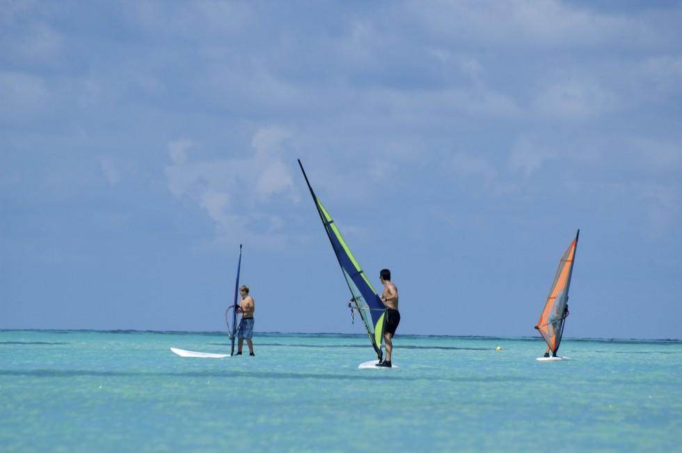 Windsurfers training in the water.