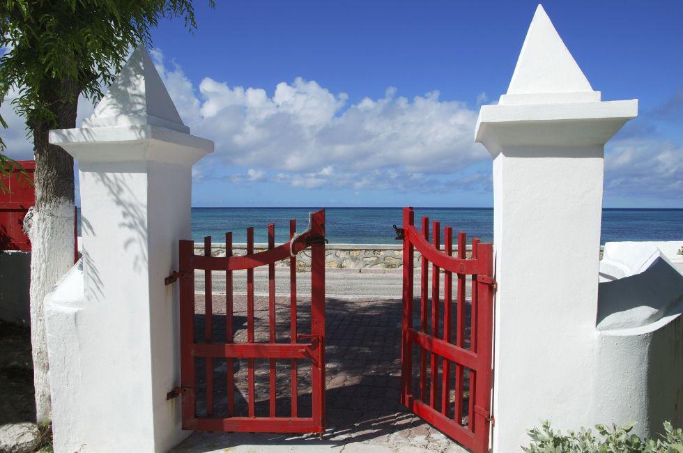 The red gates of the cathedral that leads to the sea in Cockburn town on Grand Turk island (Turks &amp; Caicos).