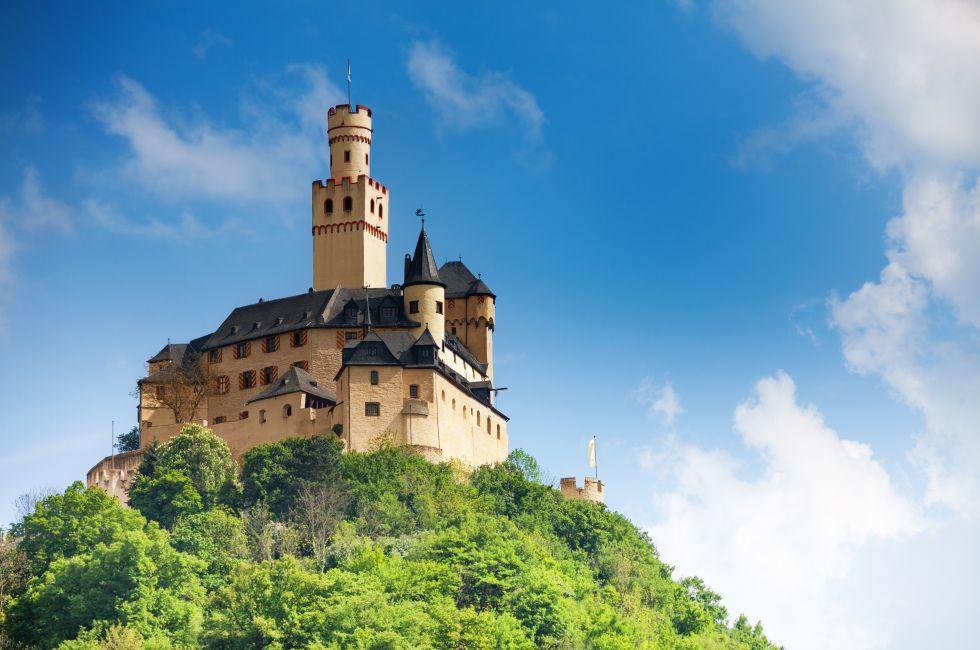 View Marksburg castle in Germany, Europe over blue sky on top of the high mountain.