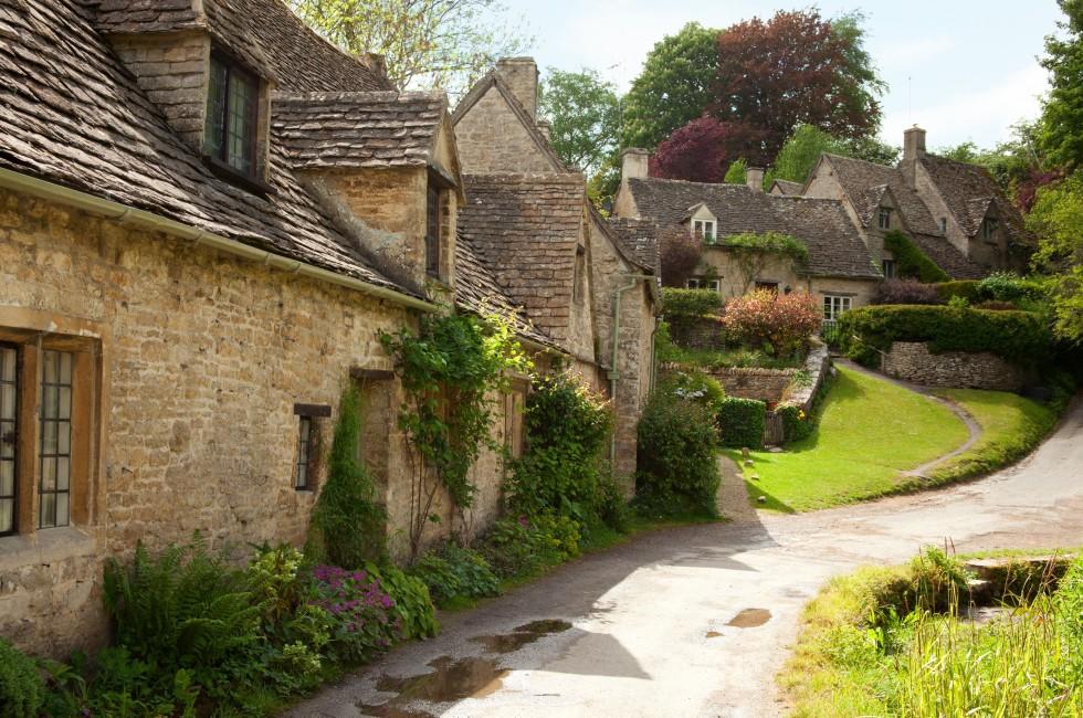 Traditional Cotswold cottages in England, UK.  after the rain. spring. Bibury is a village and civil parish in Gloucestershire, England.