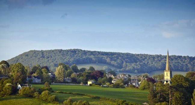 Idyllic rural view of gently rolling patchwork farmland and villages with pretty wooded boundaries, in the beautiful surroundings of the Cotswolds, England, UK.