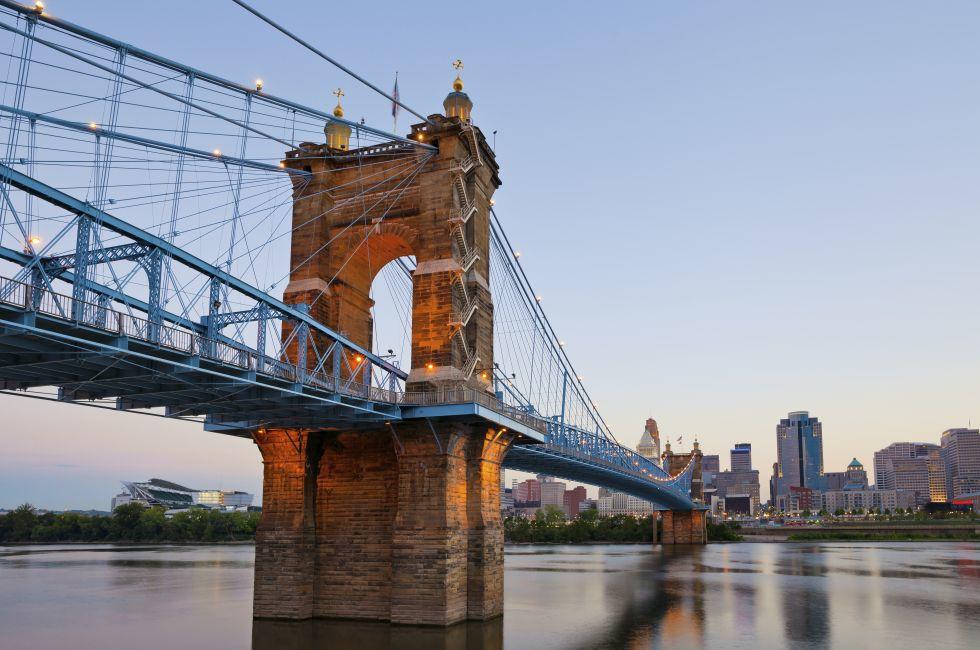 Cincinnati. Image of Cincinnati and John A. Roebling suspension bridge at twilight. 