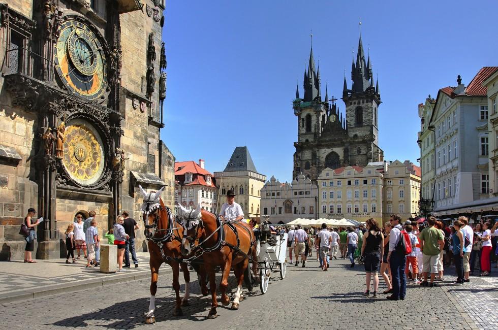 PRAGUE - JULY 17 : Tourist carriage passes by Old Town Square (Stare Mesto) in front of Tyn Church and famous Astronomical Clock july 17, 2009 in Prague, Czech Republic.