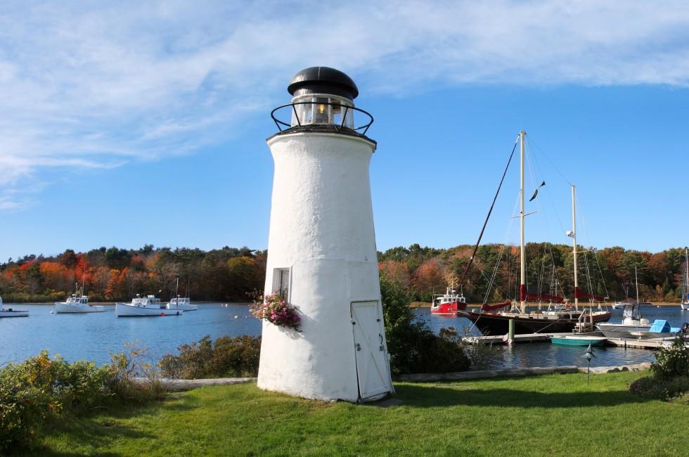A Small Decorative Lighthouse And Boats In Harbor At Kennebunkport, Maine, USA, Panoramic View.