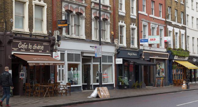 LONDON, UK - 26TH MARCH 2015: A view of various restaurants and businesses along Upper Street in Islington, london. People can be seen.