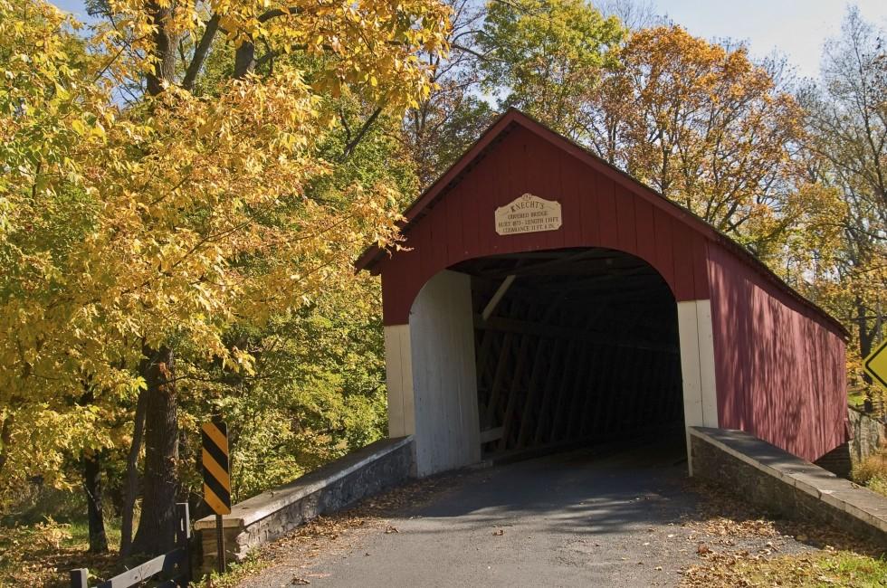 An Autumn view of the historic Knechts Covered Bridge in rural Bucks County, Pennsylvania.