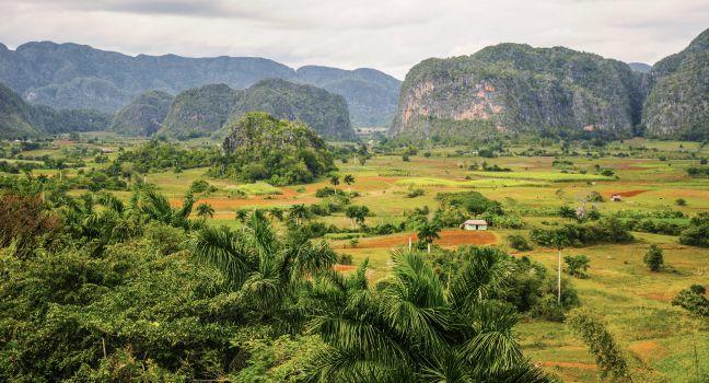 VINALES VALLEY, CUBA - JANUARY 19, 2013. Panoramic landscape view over farm fields in Vinales Valley, Pinar Del Rio province in Cuba, famous for tobacco plantations, caves and Valley itself.