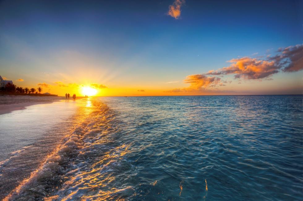 Grace Bay Beach, Turks &amp; Caicos, with the setting sun at the horizon.