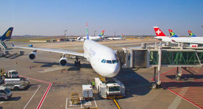 JOHANNESBURG - APRIL 18:Airbus A340 disembarking passengers after intercontinental flights on April 18, 2012 in Johannesburg, South Africa. Johannesburg Tambo airport is the busiest airport in Africa